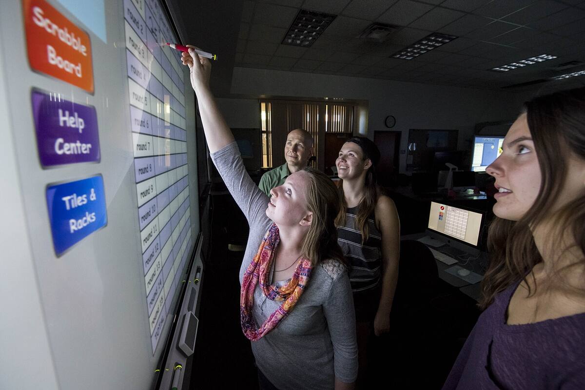 visitors at a large touchscreen