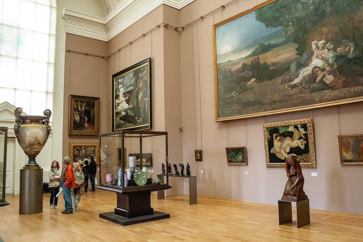 A museum gallery hung with paintings